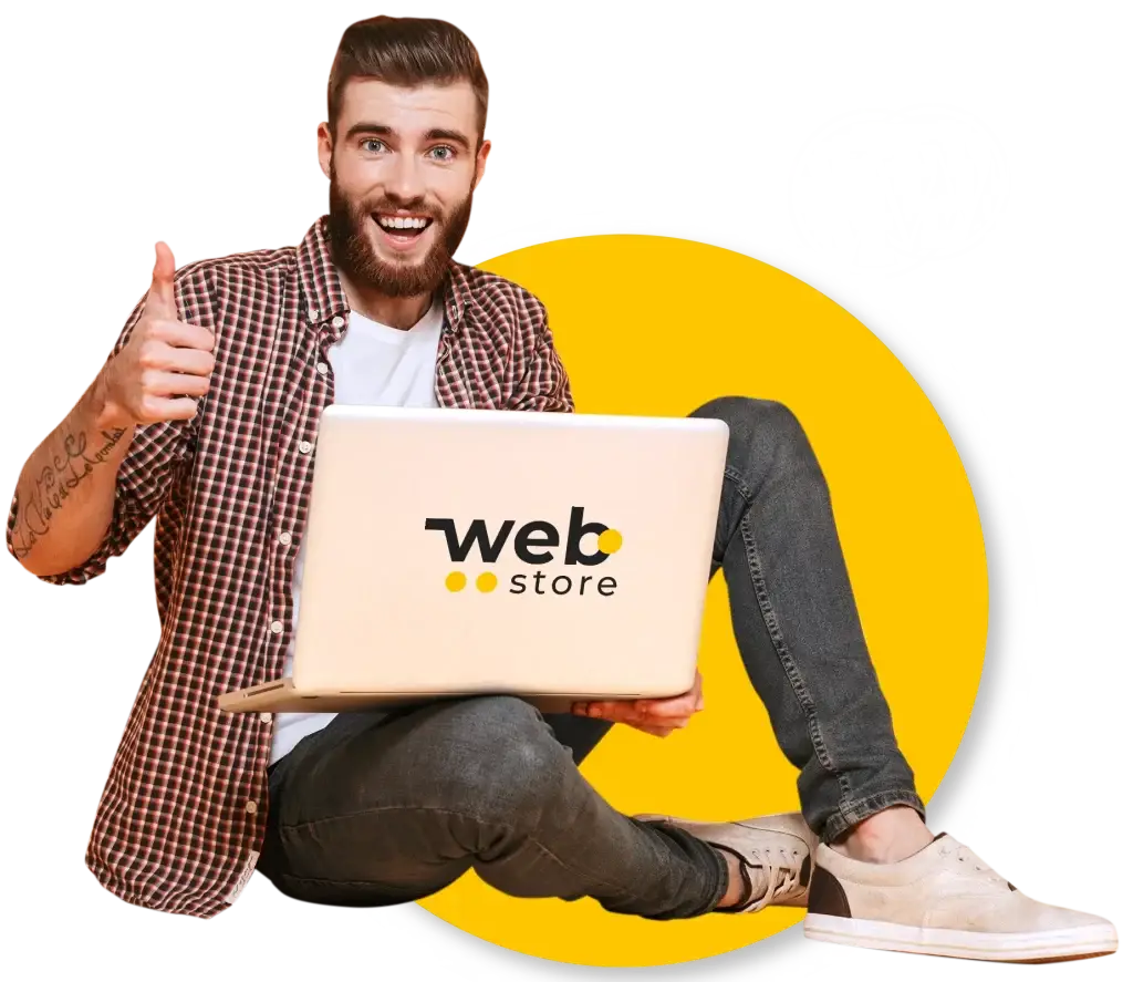 hombre sentado con laptop de webstore en la mano